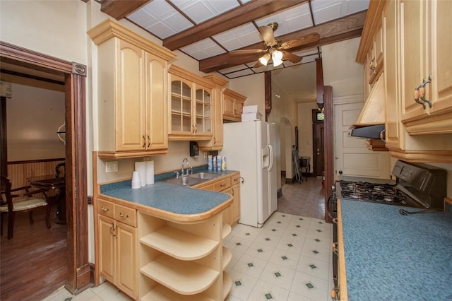 kitchen featuring light brown cabinets, range with gas stovetop, white refrigerator with ice dispenser, and sink