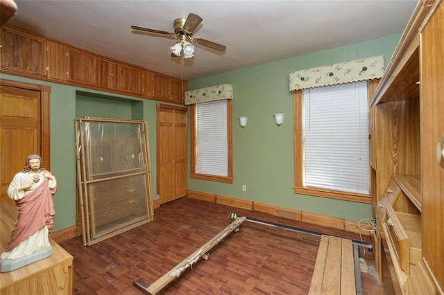 unfurnished bedroom featuring ceiling fan, dark wood-type flooring, and a closet