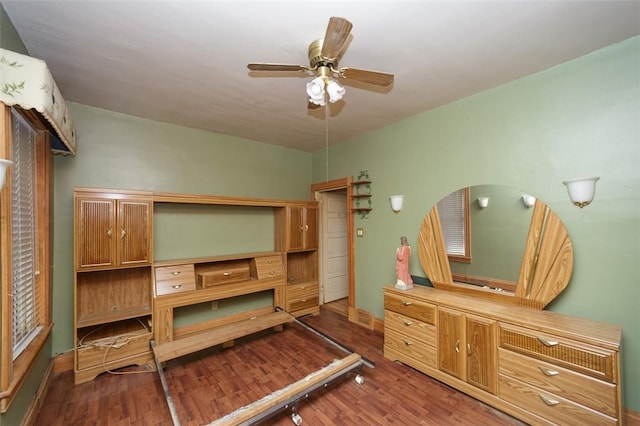 bedroom featuring ceiling fan and dark wood-type flooring