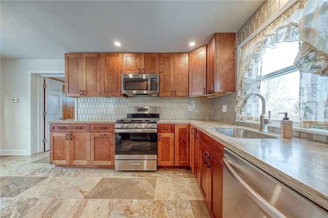 kitchen featuring decorative backsplash, sink, and stainless steel appliances