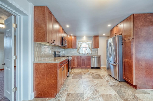 kitchen with tasteful backsplash, sink, and appliances with stainless steel finishes