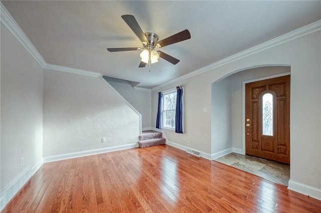 entryway with ceiling fan, ornamental molding, and light hardwood / wood-style flooring