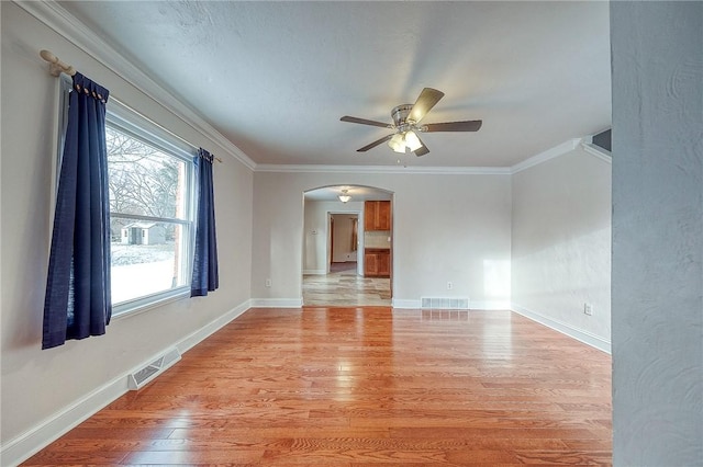 unfurnished room with ceiling fan, light hardwood / wood-style flooring, and ornamental molding