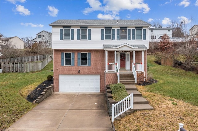 view of front of property featuring a front yard and a garage