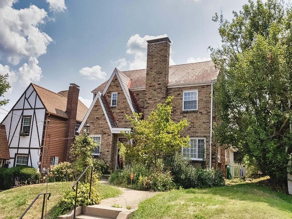 tudor-style house featuring a front yard