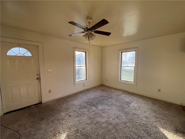 entrance foyer featuring carpet, a wealth of natural light, and ceiling fan