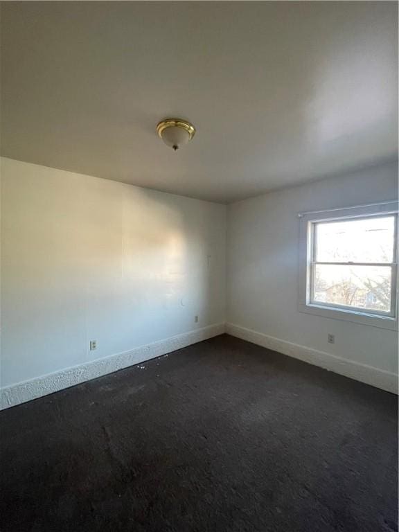 empty room with dark colored carpet