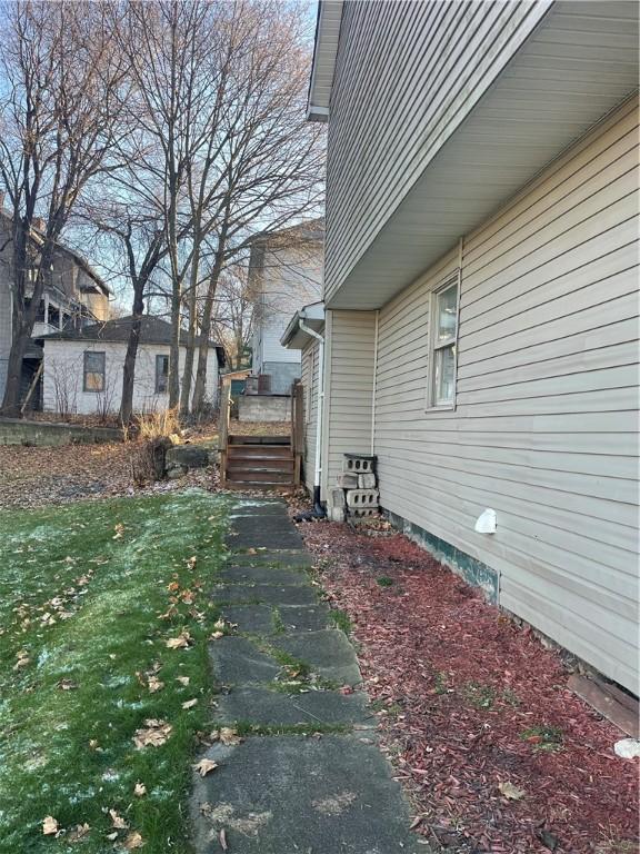 view of side of home with a yard