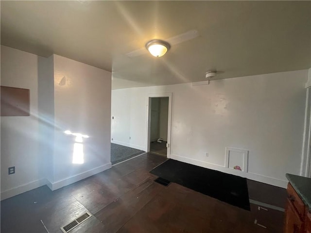 spare room with dark hardwood / wood-style flooring