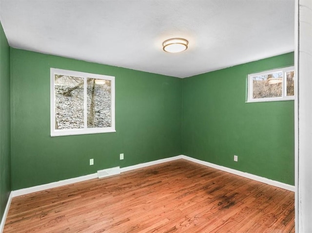 unfurnished room featuring hardwood / wood-style floors