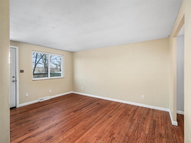 unfurnished room featuring hardwood / wood-style flooring