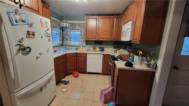 kitchen with white appliances and light tile patterned flooring