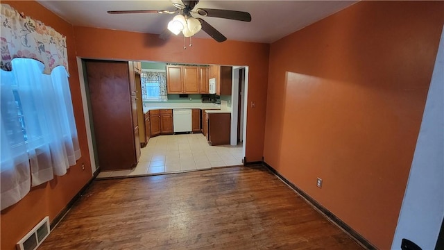 kitchen with ceiling fan, white dishwasher, and light hardwood / wood-style floors