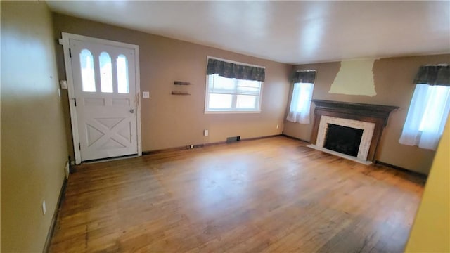 unfurnished living room featuring light hardwood / wood-style floors