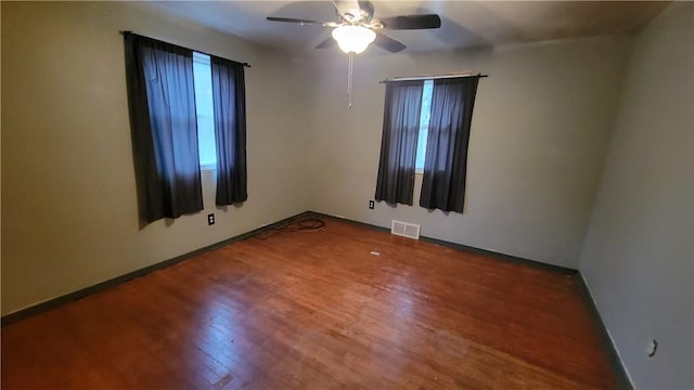 unfurnished room with hardwood / wood-style flooring and ceiling fan