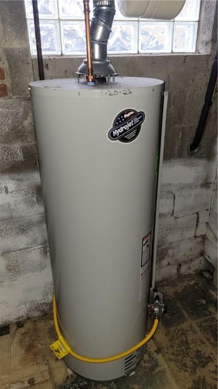 utility room featuring gas water heater