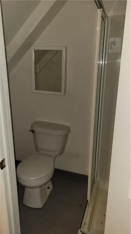 bathroom featuring lofted ceiling, an enclosed shower, and toilet