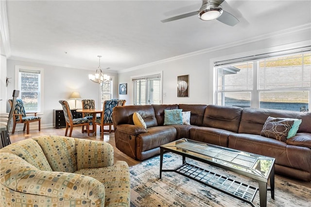 living room with ceiling fan with notable chandelier, light hardwood / wood-style floors, and crown molding