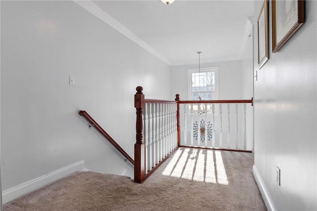 stairway featuring a chandelier, carpet floors, and ornamental molding