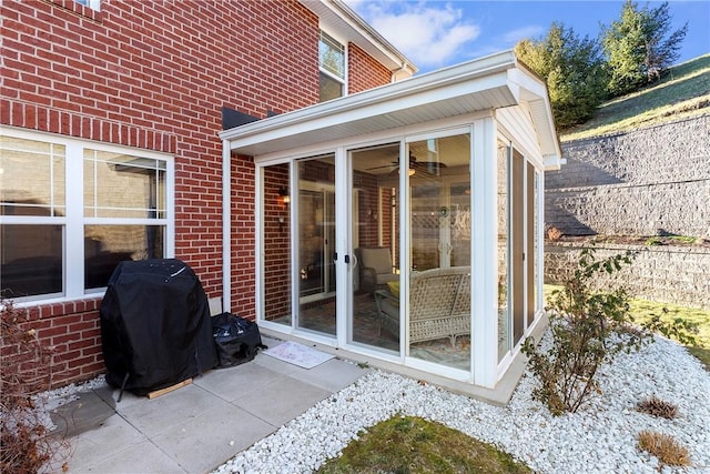 view of patio featuring grilling area and a sunroom