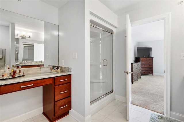 bathroom featuring vanity and a shower with shower door