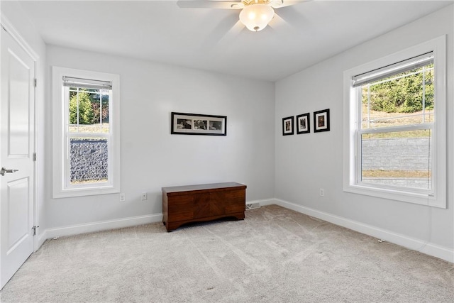 carpeted spare room with ceiling fan