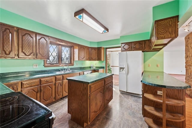 kitchen featuring a center island, white appliances, and sink