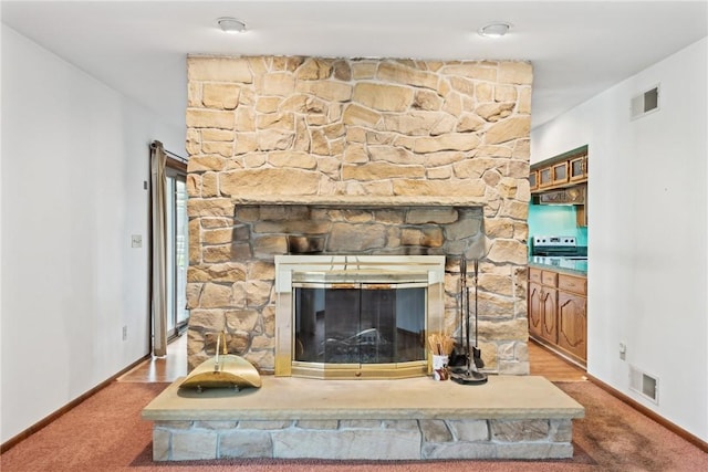 interior details featuring a fireplace and carpet floors