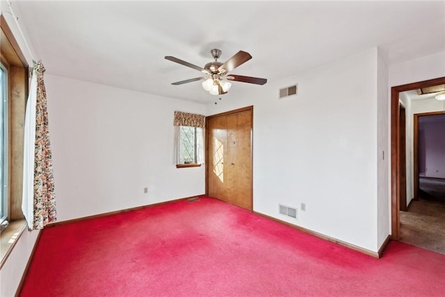 unfurnished bedroom featuring ceiling fan and carpet