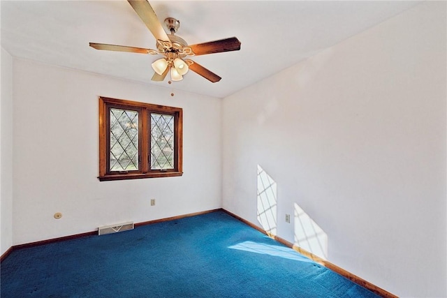 carpeted spare room featuring ceiling fan