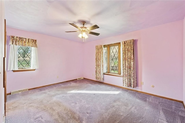 carpeted empty room featuring ceiling fan