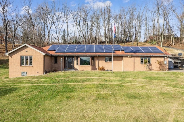 back of house featuring solar panels and a yard