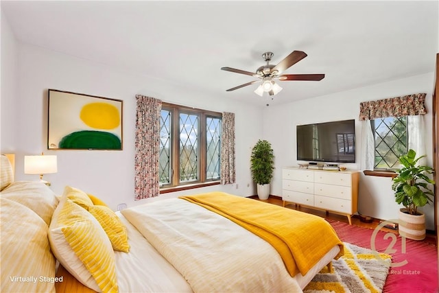 bedroom with multiple windows and ceiling fan