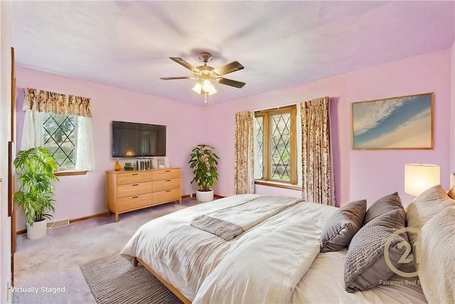 bedroom with ceiling fan and light carpet