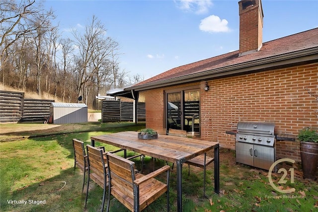 view of patio / terrace with a shed and grilling area