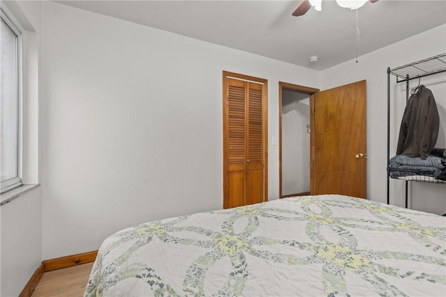 bedroom with light hardwood / wood-style floors and ceiling fan