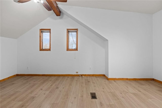 additional living space with vaulted ceiling with beams, light hardwood / wood-style floors, and ceiling fan