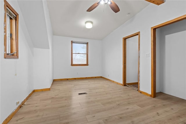 unfurnished bedroom featuring ceiling fan, lofted ceiling, and light wood-type flooring