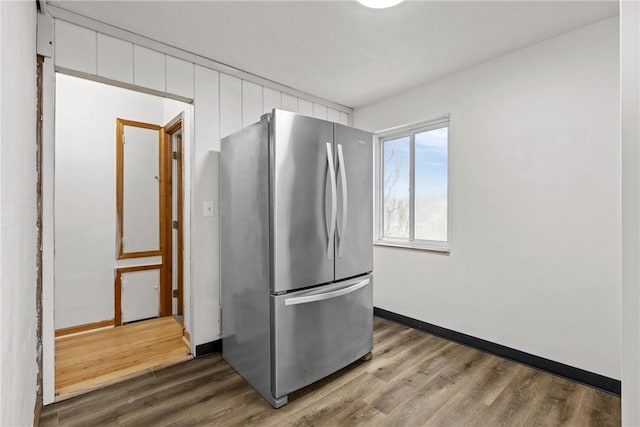 kitchen with stainless steel refrigerator and dark wood-type flooring