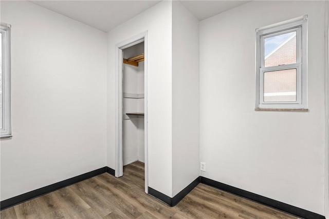 unfurnished bedroom featuring hardwood / wood-style floors and a closet