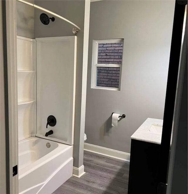 full bathroom with vanity, toilet, wood-type flooring, and tub / shower combination