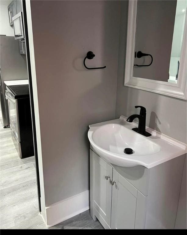 bathroom featuring hardwood / wood-style floors and vanity