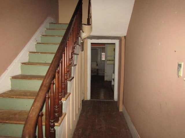 stairs featuring wood-type flooring