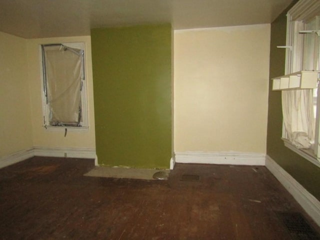 spare room featuring wood-type flooring