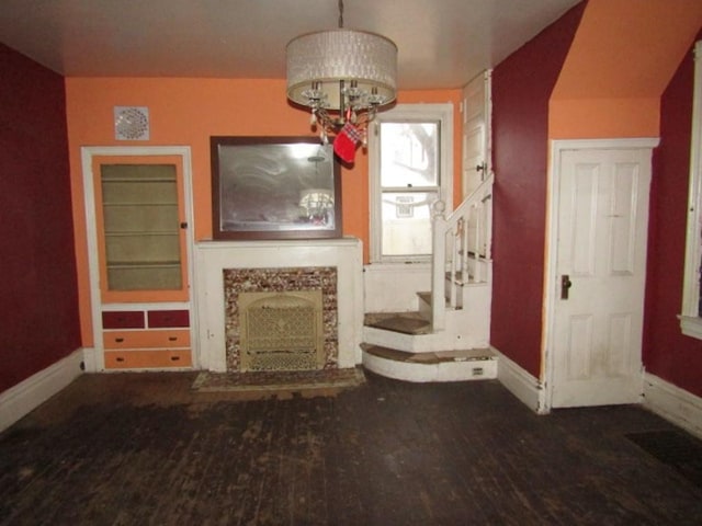 unfurnished living room featuring a fireplace and wood-type flooring