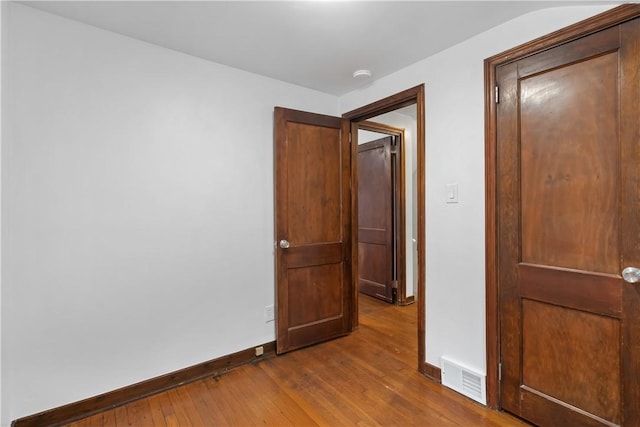 spare room featuring hardwood / wood-style floors