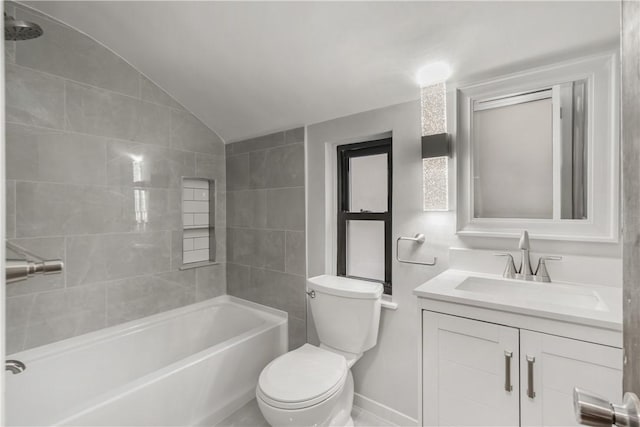 full bathroom with vanity, tiled shower / bath combo, lofted ceiling, and toilet