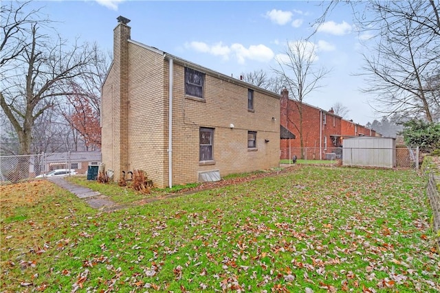 rear view of property with a yard