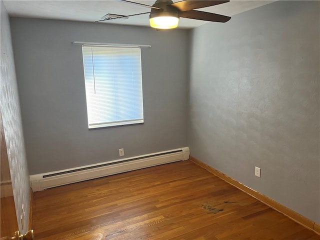 unfurnished room featuring hardwood / wood-style floors, ceiling fan, and a baseboard heating unit