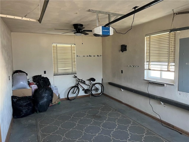 garage featuring ceiling fan, a garage door opener, and electric panel